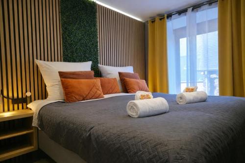 a bedroom with a large bed with pillows on it at VonMos Moselblick Apartments in Kinheim
