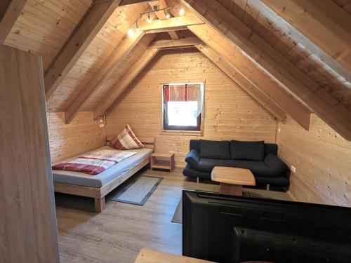 a living room with a couch in a wooden house at Studio DG für 1 Person in Kelheim