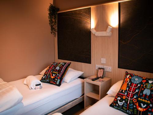 a small room with two beds and a table at Gardiner House Hostel in Dublin