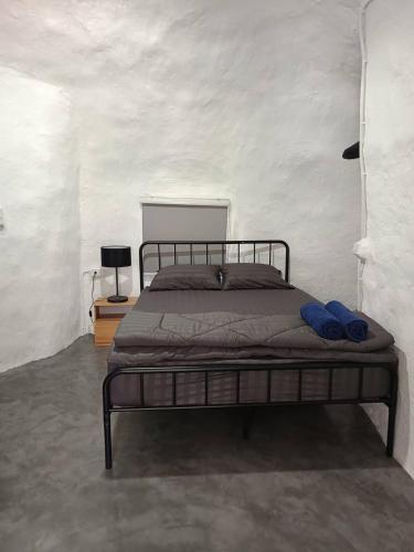 a bedroom with a bed with blue shoes on it at Art rock garden in Ko Lipe