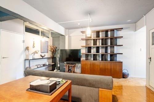 a living room with a couch and a table at 田 Den Kamakura Petと泊まれる ペット滞在費別途 in Kamakura