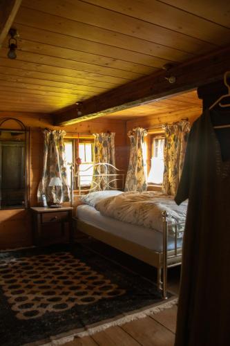 a bedroom with a bed in a wooden room at Bauernhaus auf dem Land in Hebertsfelden