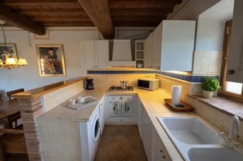 a kitchen with a sink and a counter top at Borgo Sette Tigli in Montepulciano