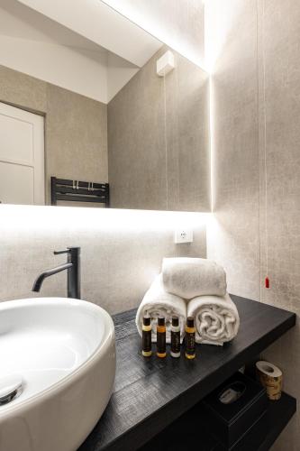 a bathroom with a sink and a white tub at Seta Hotel in Bellagio