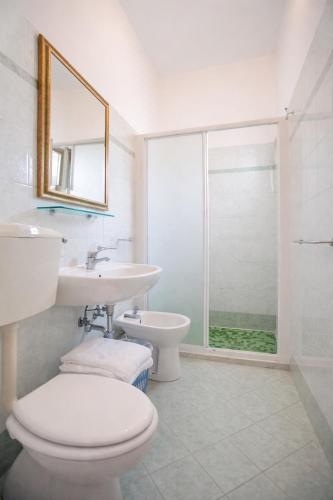 a bathroom with a toilet and a sink and a shower at Villa Silvie Rose in Cesenatico