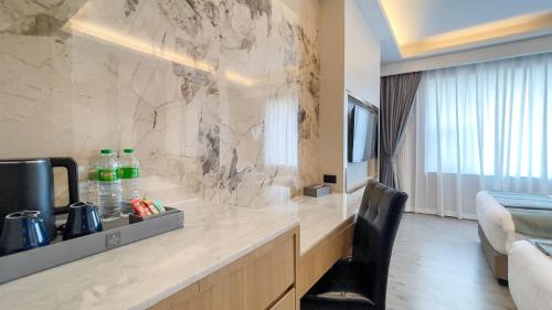 a hotel room with a counter and a room at Enrich Grand Hotel in Bangkok
