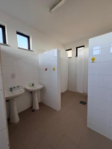 a bathroom with two sinks and two toilets at Lagartoca in Vilar de Amargo