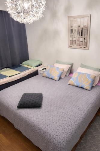 a bedroom with two beds and a chandelier at Top in Oulu