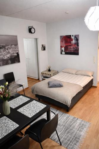 a bedroom with a bed and a table and chairs at Top in Oulu