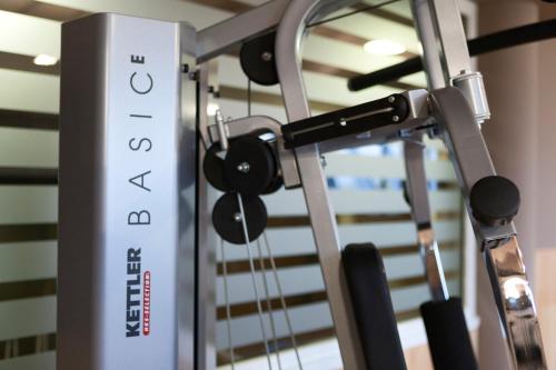 a gym with a rack with weights at Albavilla Hotel & Co in Albavilla