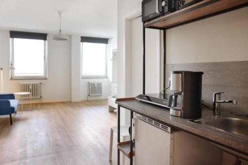 a kitchen with a sink and a counter top at Zentrale Monteurwohnung in Oldenburg i H in Oldenburg in Holstein