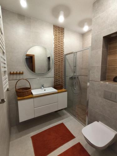 a bathroom with a sink and a shower and a toilet at Chata na Psiaku in Wrocław