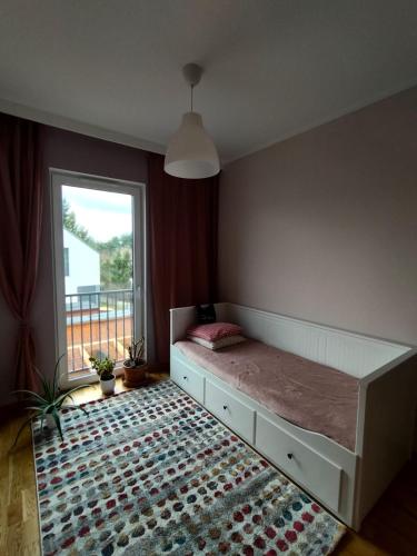 a bedroom with a large bed and a window at Chata na Psiaku in Wrocław
