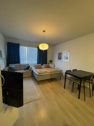a living room with a couch and a table at Apartment with a wonderful location! in Lappeenranta