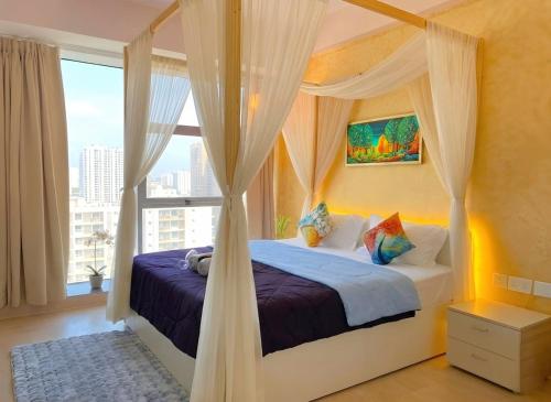 a bedroom with a canopy bed with a window at 1BHK Suite with Balcony and Pool View in Noida