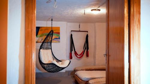 a room with a hammock hanging on the wall at Camera Alcova in giardino in Cellino Attanasio