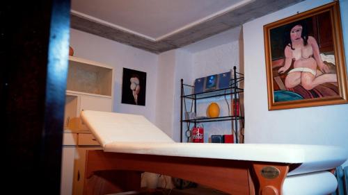 a room with a bed and a picture of a man at Camera Alcova in giardino in Cellino Attanasio