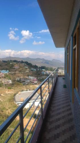 a balcony of a building with a view of a city at VAIBHAV VILAs in Gangolihāt
