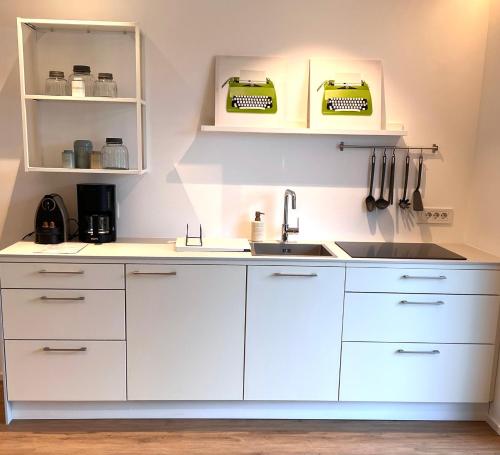 a kitchen with white cabinets and a sink at Villa Maria in Rablà