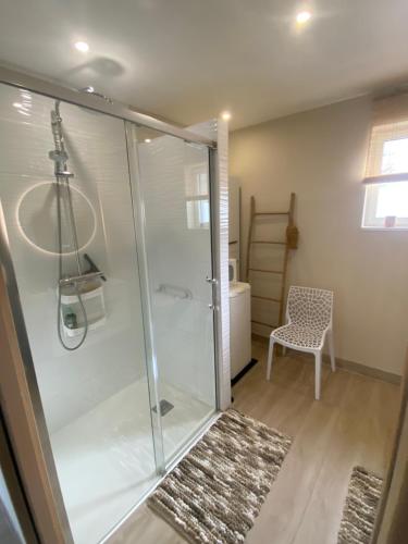 a bathroom with a shower with a glass shower stall at Villa Les Sables in Condette