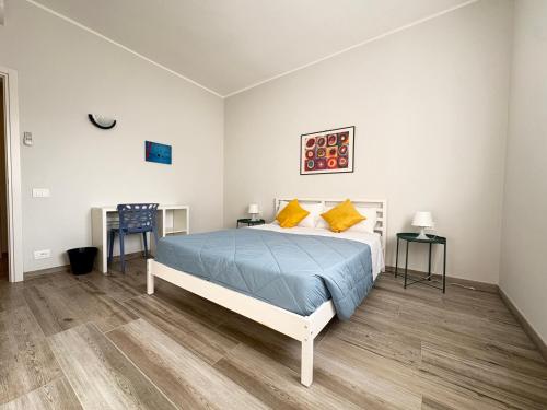 a bedroom with a bed and two tables at Sabo Urban Stay in Grassobbio