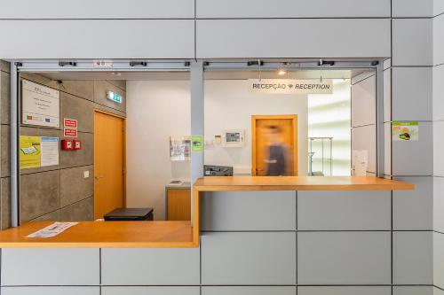 a lobby of a hospital with a glass wall at Hi Espinho - Pousada de Juventude in Espinho