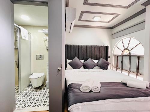 a bedroom with a bed and a tub and a sink at Rovigo Hotel in Istanbul
