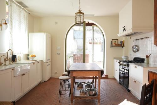 a kitchen with a table in the middle of it at La Torre Retreat in Borredá
