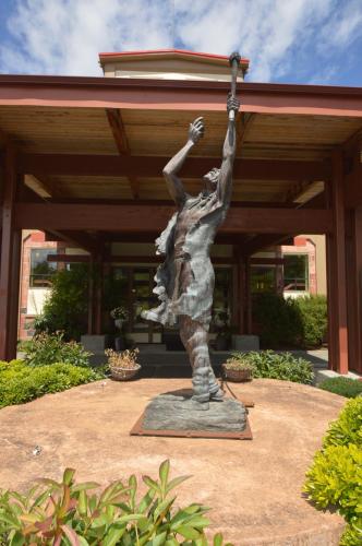 a statue in front of a building with at Old Alcohol Plant in Port Hadlock