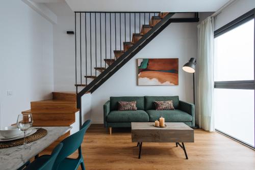 a living room with a green couch and a table at Alameda 1851 - Private jacuzzi in Seville