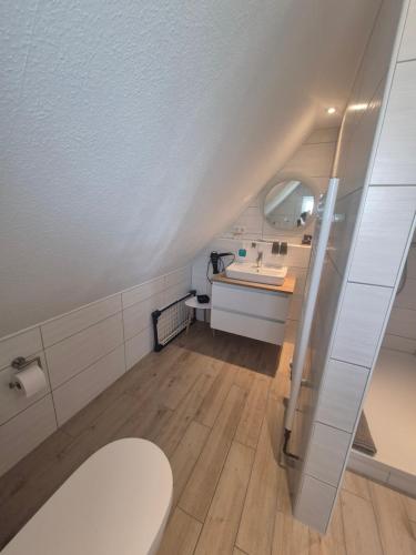 a bathroom with a toilet and a sink at Apartmenthaus Westerkoog in Hedwigenkoog
