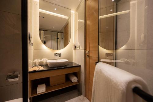 a bathroom with a sink and a mirror at Ananta Express, Katra in Katra