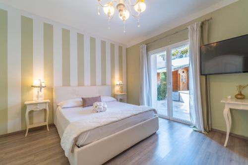 a bedroom with a bed and a large window at Les Suites Magnolia in Olbia