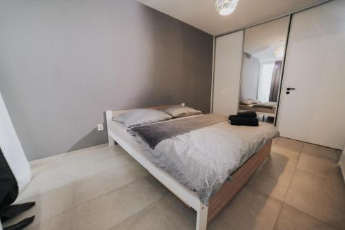 a bedroom with a bed and a large mirror at Apartmán Melissa in Žilina