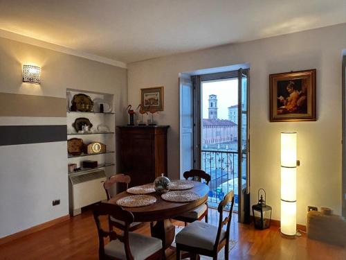 a dining room with a table and chairs and a balcony at Il re di Torino in Turin
