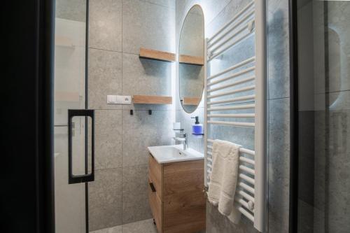 a bathroom with a sink and a mirror at Apartmán Sekvoja in Nová Baňa