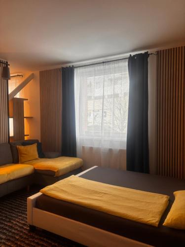 a bedroom with two beds and a window at Apartmán CENTRAL, free parking in Banská Bystrica