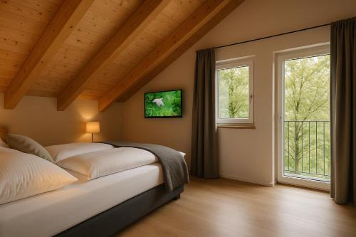 a bedroom with a bed and two windows at Seelos - Alpine Easy Flats in Mieming