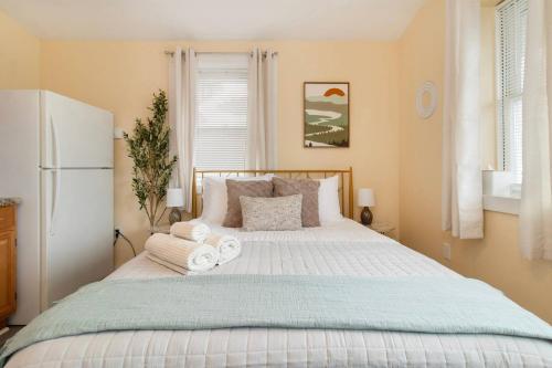 a bedroom with a large bed with towels on it at Chic Groton Studio • A Cozy, Modern & Central Gem in Groton