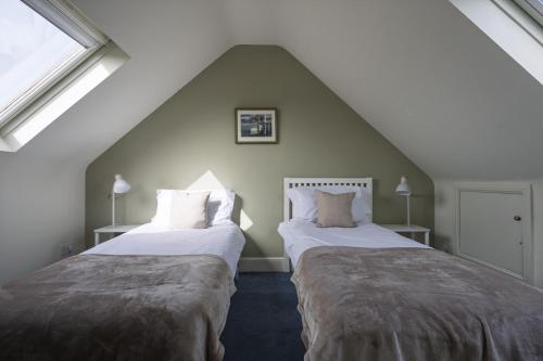 two beds in a room with a attic at Haven House in Lymington
