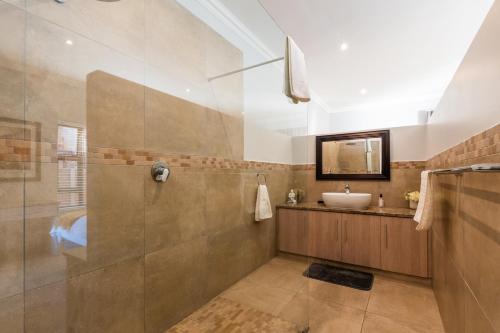 a bathroom with a shower and a sink at Seemeeu, Gouritsmond in Gouritzmond