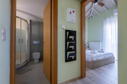 a bedroom with a bed and a bathroom with a mirror at Panorama City Loft in Mytilene