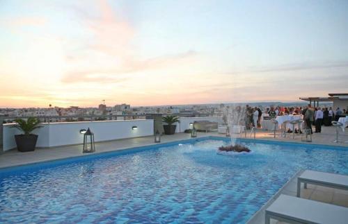 a large swimming pool on the roof of a building at Eden Beach Apartment 207 in Limassol