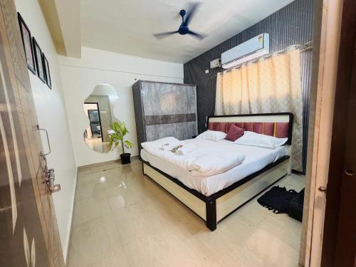 a bedroom with a bed in a room at The Hampiness Studio 2 in Hospet