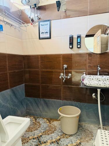 a bathroom with a toilet and a sink at The Hampiness Studio 2 in Hospet