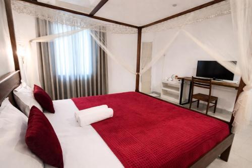 a bedroom with a large bed with a red blanket at W Hotel Mount Lavinia - Colombo in Colombo