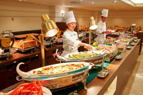a group of chefs preparing food in a kitchen at Sunshine City Prince Hotel Ikebukuro Tokyo in Tokyo