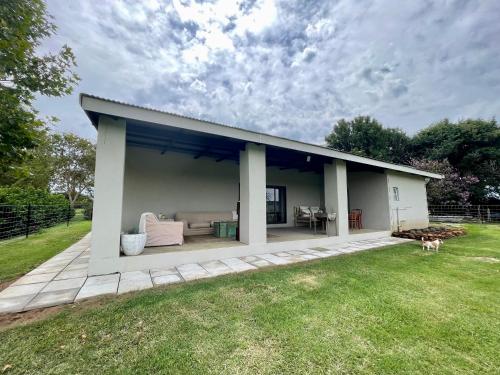 a pavilion with a couch and a table in a yard at Pecan Tree Haven in Winterton