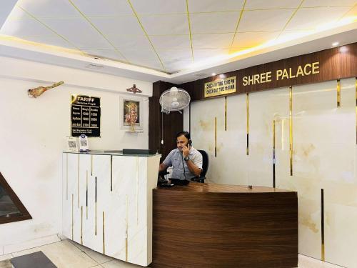 a man sitting at a counter in a fast food restaurant at hotel shree palace in Ratlām
