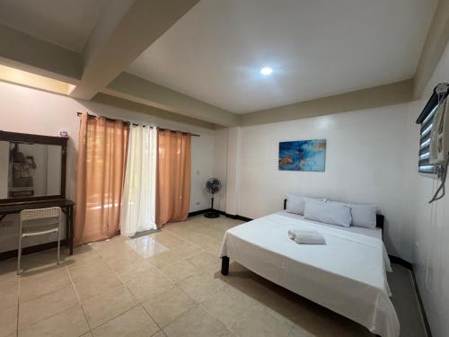 a bedroom with a bed and a television in it at Boracay Garden Retreat in Boracay